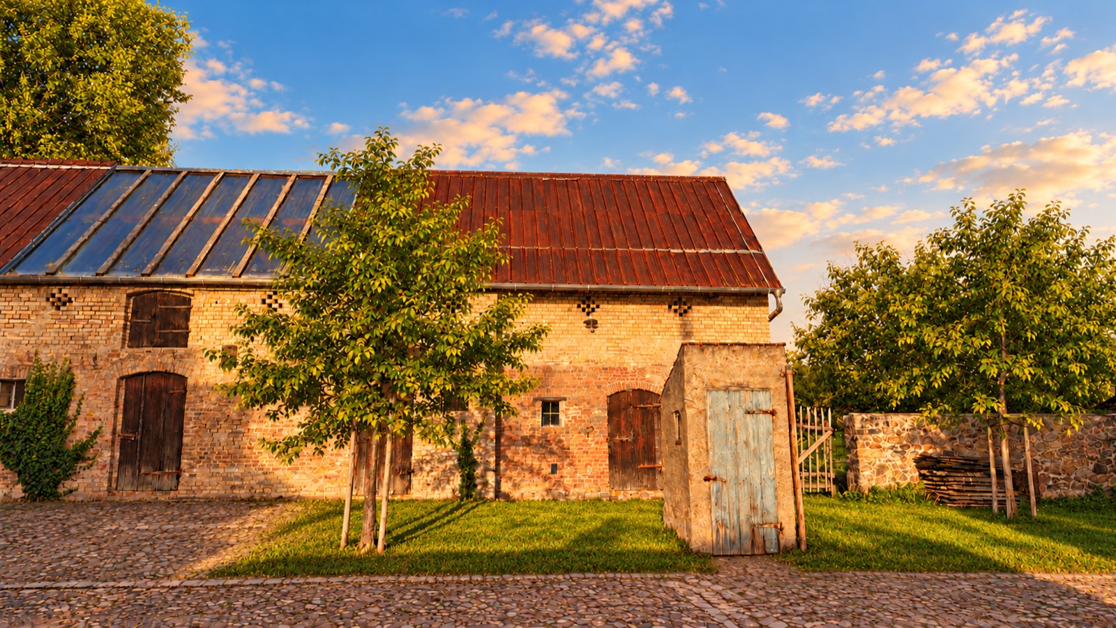 Stallgebäude mit jungen Bäumen im Hof
